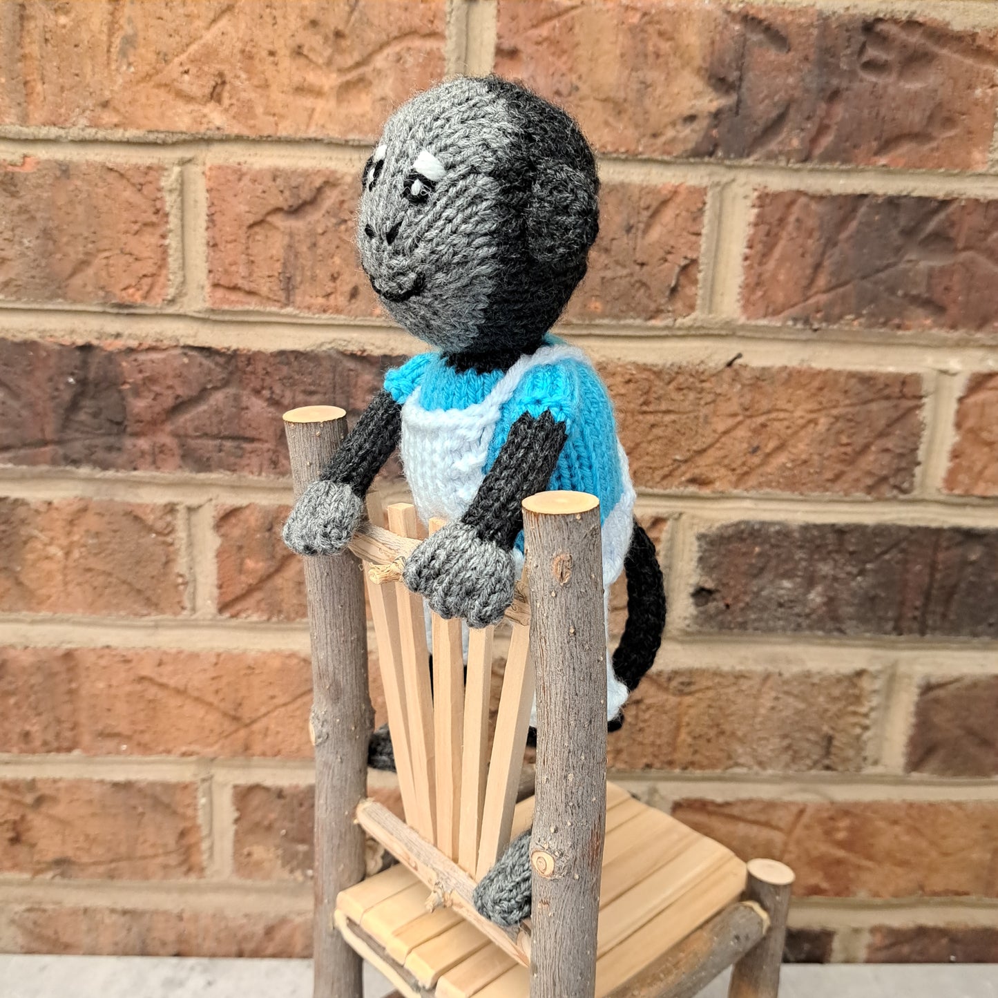 Handknit Monkey Toy - dark gray with bright blue shirt and palest blue short overalls