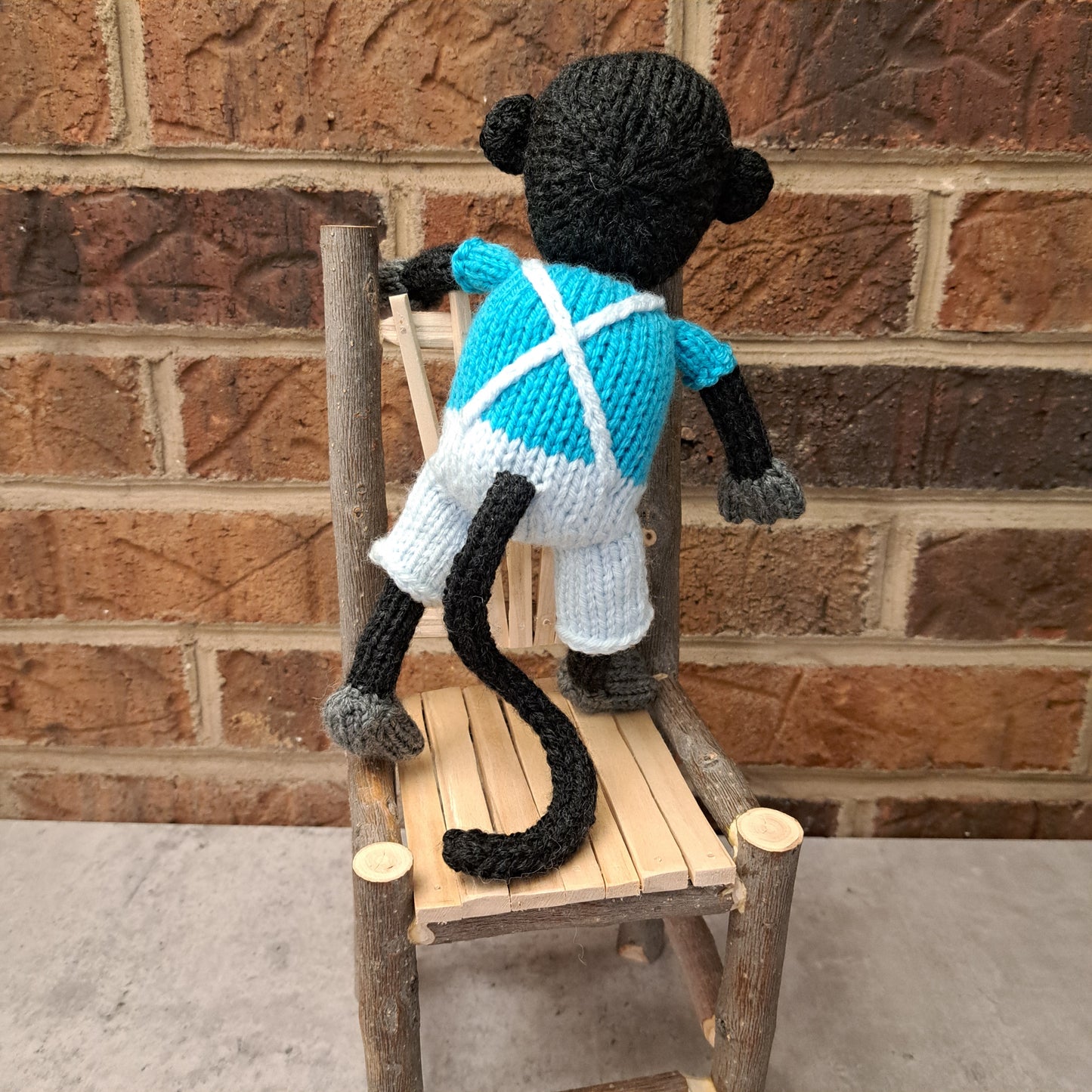 Handknit Monkey Toy - dark gray with bright blue shirt and palest blue short overalls