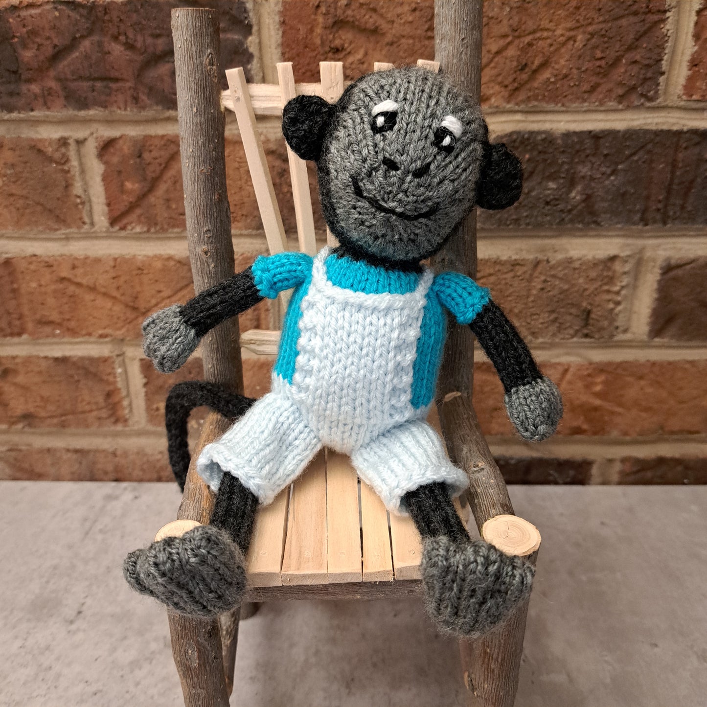 Handknit Monkey Toy - dark gray with bright blue shirt and palest blue short overalls