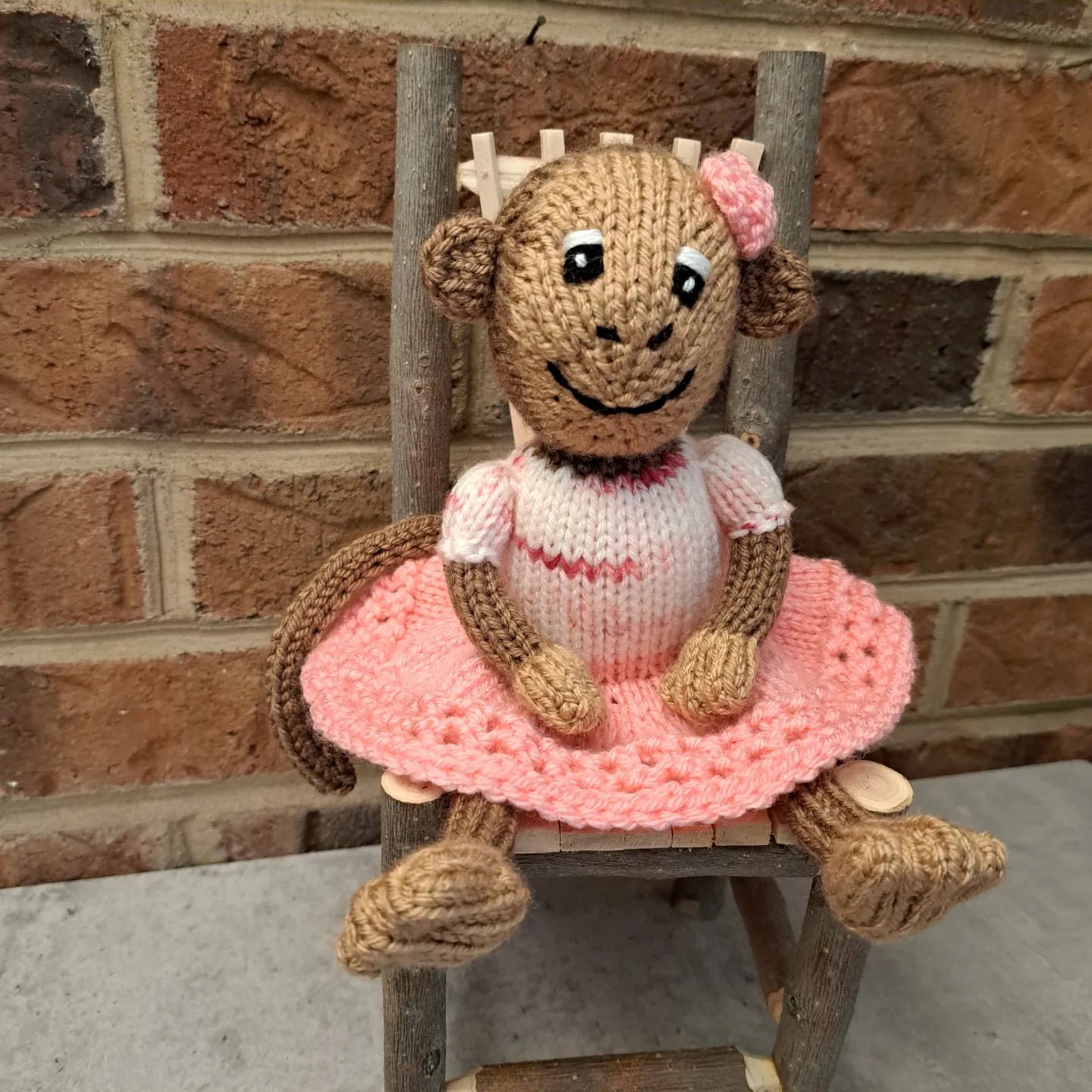 Handknit Monkey Toy - light brown with pink skirt and top