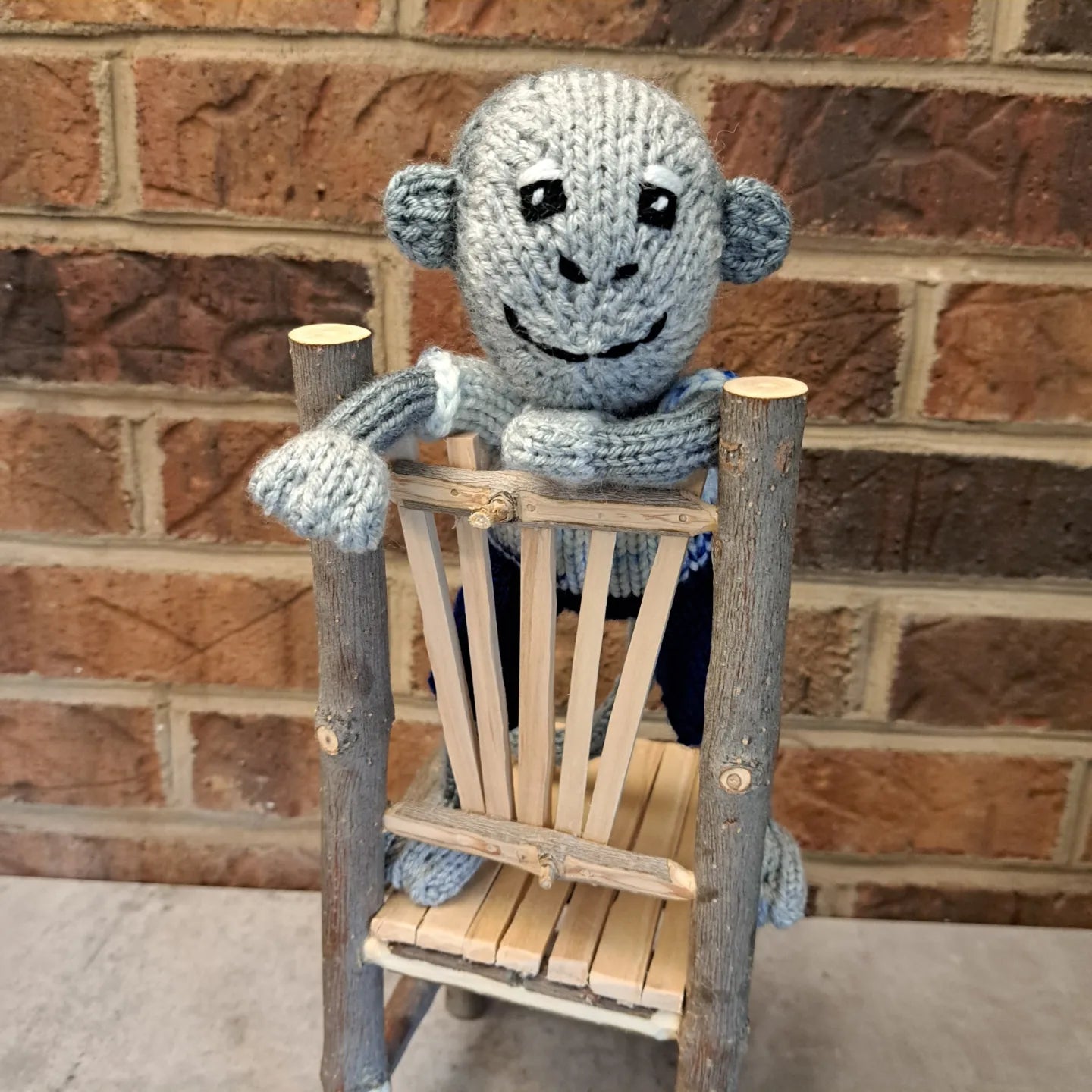 Handknit Monkey Toy - light gray with blue shorts and a white and blue speckled shirt